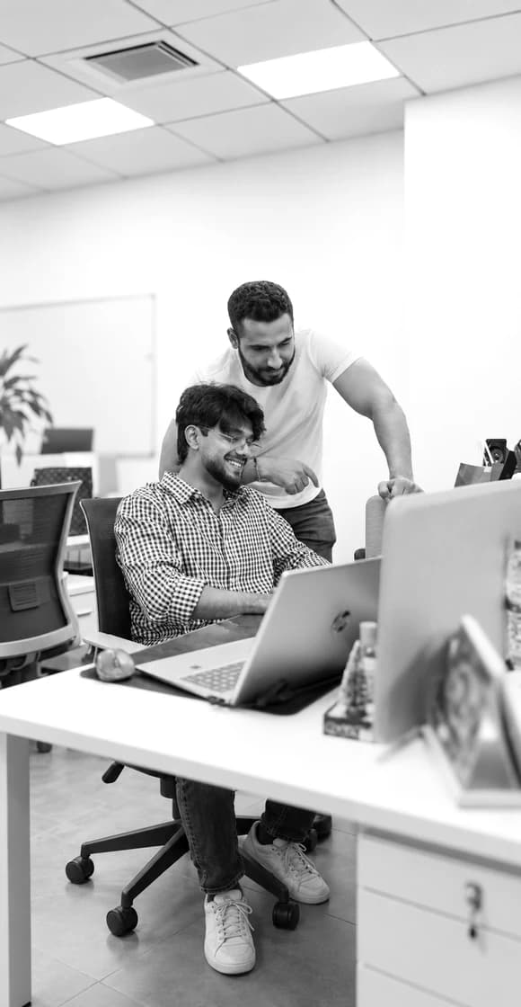 Creative team collaborating at a work table with models and plans.